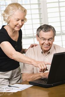 elderly couple using laptop